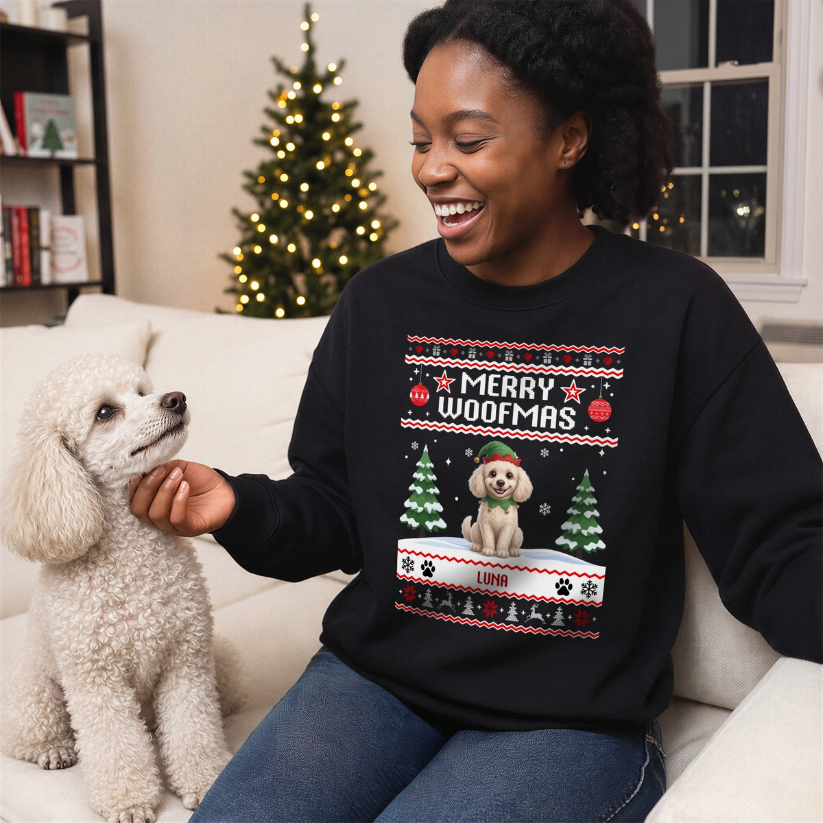 Woman in a black Merry Woofmas sweater with a cartoon of her poodle next to her dog