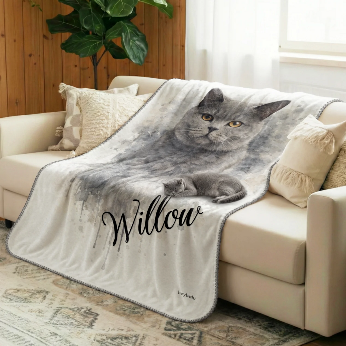 Watercolor Cat blanket with gray British Shorthair portrait draped over the sofa