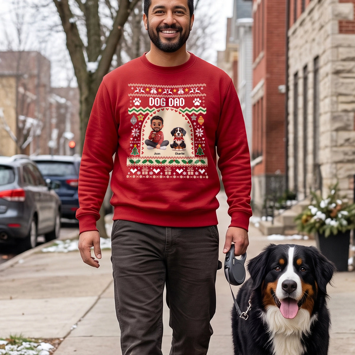 Man in a red Dog Dad sweater walking his Bernese Mountain Dog