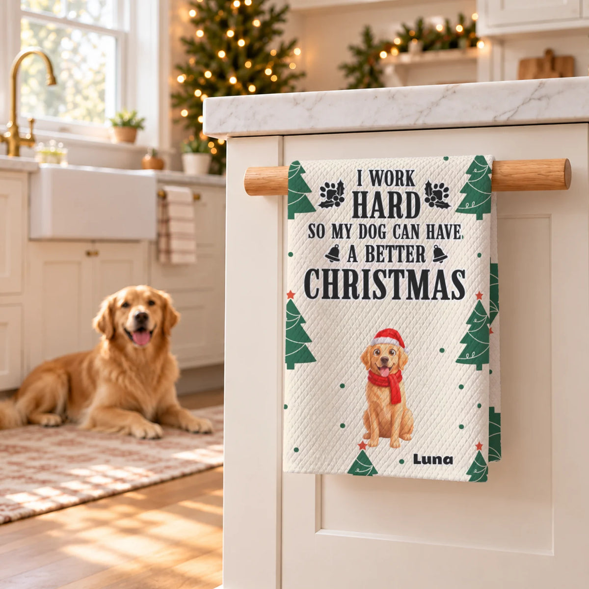 Golden retriever lies beside the Christmas Dog kitchen towel hanging in a holiday kitchen