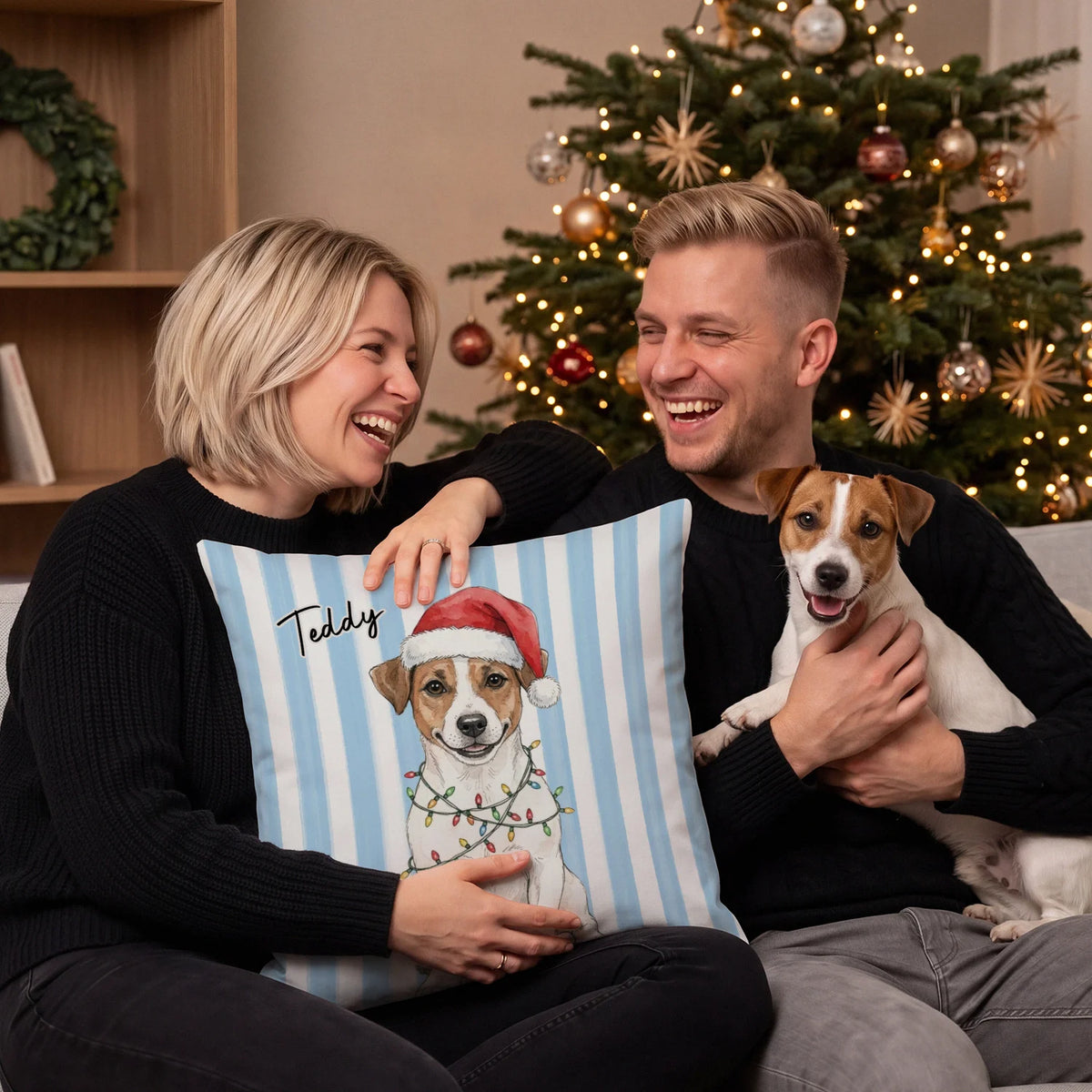 Couple with their Jack Russell and a striped pillow with the dog in a Santa hat