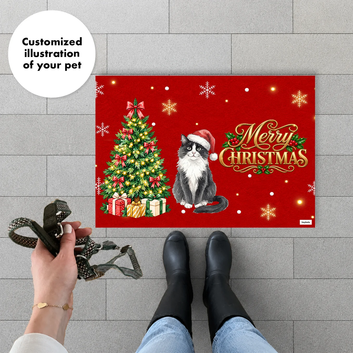 Woman with a leash standing in front of the red Christmas doormat with cat illustration