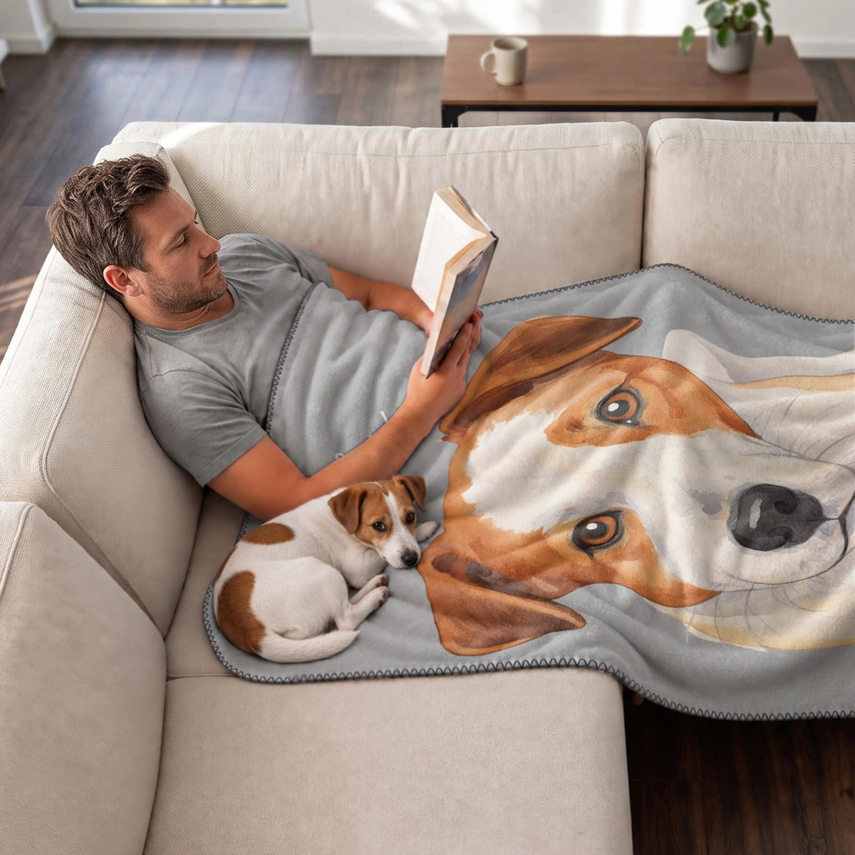 Man reads on the couch under the Portrait blanket with his Jack Russell Terrier