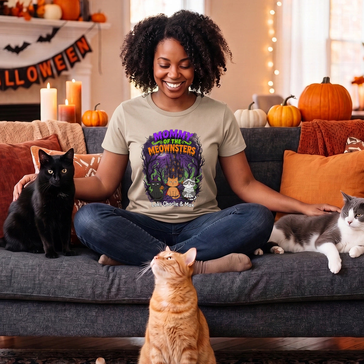 Smiling woman among black, gray and orange cats in the beige Spooky Cat Mom T-shirt