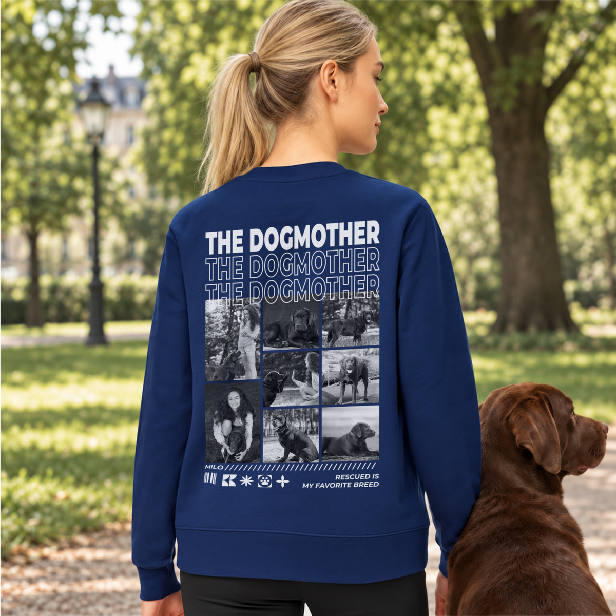 Woman in a navy The Dogmother sweater with photo collage next to a chocolate Labrador