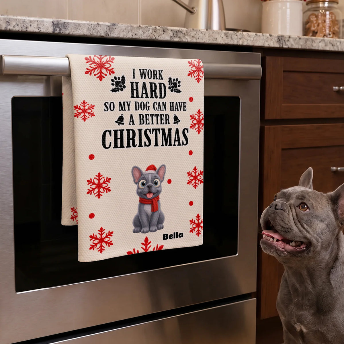 French bulldog looks up at the Christmas Dog kitchen towel hanging on the oven door