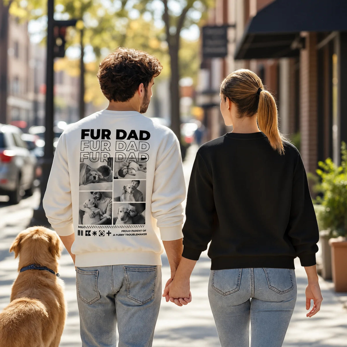 Couple walking hand in hand with a dog, the man in a white Fur Dad sweater
