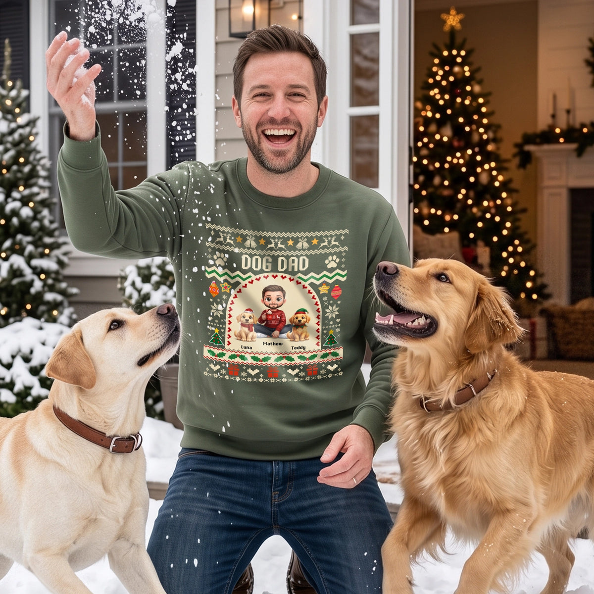 Man in a military green Dog Dad sweater with two golden retrievers in the snow